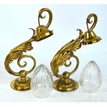 A large pair of Edwardian brass wall light fittings with foliate scroll decoration and cut glass