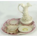 A large Belleek porcelain ewer with scrolling loop handle and moulded floral applied decoration,