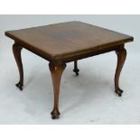 An Edwardian mahogany single leaf extending dining table.