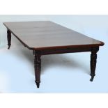 EDWARDS & ROBERTS; a Victorian walnut four leaf extending table, the rectangular top with canted