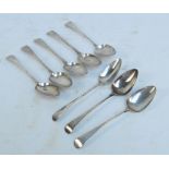 A set of four George III hallmarked silver Old English pattern tablespoons with decorated stems and