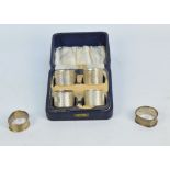A cased set of four George V hallmarked silver napkin rings, Sheffield 1937, and two others,