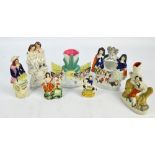 Seven Victorian Staffordshire figures including two spill vases, one decorated with hens, and a