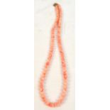 A pale coral bead necklace, length 54cm.