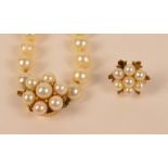 A cultured pearl single strand necklace with 9ct gold cultured pearl set floral clasp,