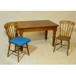 A pitch pine rectangular kitchen table raised on turned legs and four bar back kitchen chairs with
