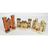 Three Victorian Staffordshire models of castles with combware ornaments, one with clock face, height