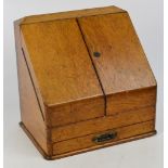 An Edwardian oak stationery cabinet, the hinged angled top enclosing "Answered",