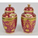 A pair of early 20th century Vienna porcelain ovoid jars and covers each transfer decorated with