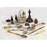 A collection of plated items including a three piece cruet on stand, a small ivory handled spade,