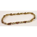 A 9ct gold bracelet with garnet coloured stones, length 19.5cm.