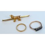 A 9ct yellow gold bar brooch centred on a model of a spaniel, a small 9ct gold wedding band,