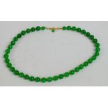 A jade bead necklace, length 48cm.