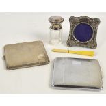 A George VI hallmarked silver rectangular cigarette case with overall engine turned decoration and