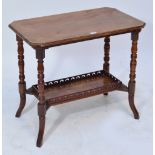 A late Victorian walnut two tier rectangular occasional table on outswept supports.