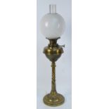 A late Victorian brass oil lamp converted to electricity with opaque globular shade,