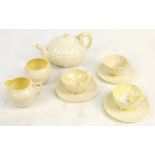 A Belleek part tea set, comprising teapot, three cups and saucers, jug and bowl, each piece with