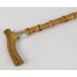 A horn handled bamboo walking cane with white metal mounts, length 88cm.