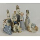 A group of Nao and Nao type figures including a seated girl beside a bird,