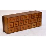 A bank of pine drawers with 22 various sized drawers, width 124cm. CONDITION REPORT: Very rustic but