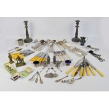 A quantity of silver plate including flatware, pair of candlesticks, loose flatware,