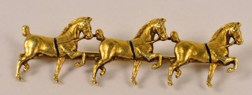 An unusual 14ct gold bar brooch modelled as three prancing horses, length 4.5cm, approx 5g.
