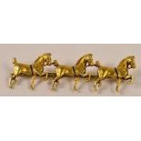 An unusual 14ct gold bar brooch modelled as three prancing horses, length 4.5cm, approx 5g.