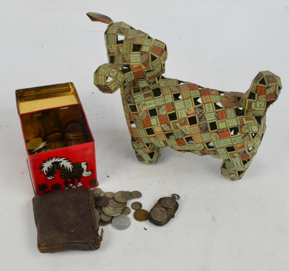 A very unusual dog made from cut and folded packets of Will's Cigarettes, also a quantity of coins.