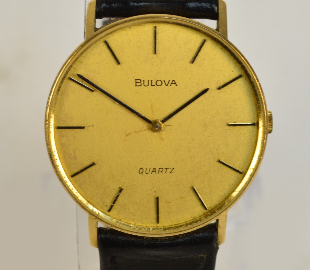 BULOVA; a 9ct yellow gold cased quartz gentleman's wristwatch, the circular dial set with baton