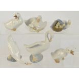 A Lladro figure group of a goose and goslings, four further Nao figures of geese,