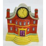 An unusual Victorian Staffordshire model of a mansion house with clock face and apertures to the
