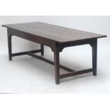 A late 18th/early 19th century plank top refectory table raised on square section tapering legs