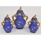 A mid 19th century English three piece garniture in the Oriental manner, the larger twin handled