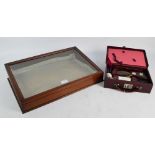 A mahogany framed glass topped sloping display cabinet, width 51cm and a travelling case,