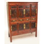 A 19th century Chinese lacquered hardwood marriage cabinet with a pair of cupboard doors flanked by