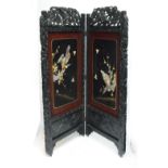 A large Japanese Meiji period two leaf folding screen with raised Shibayama style panels and dragon