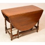 An early 20th century oak dropleaf gateleg dining table.