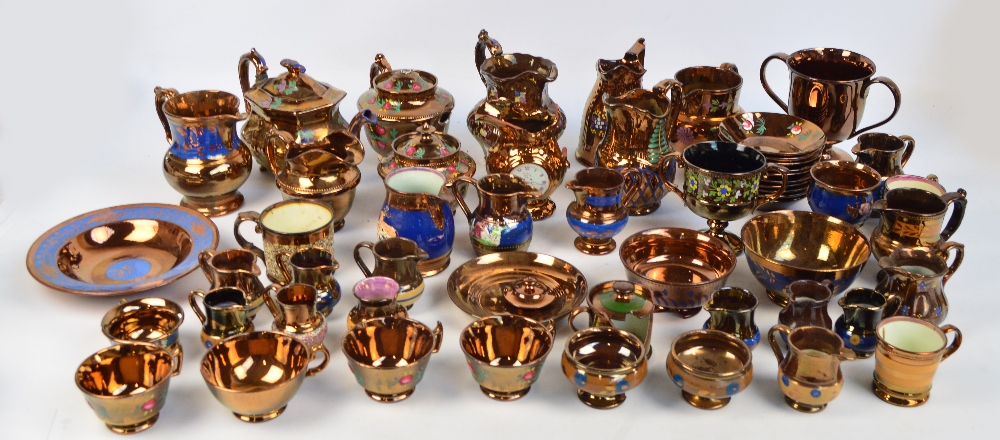 A large quantity of copper lustre ware including a three piece tea set with some cups and saucers,