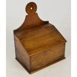 A 19th century mahogany salt box with raised back plate and hinged sloping lid, width 24cm.