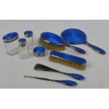 A George V hallmarked silver backed and blue guilloche enamel decorated nine piece dressing table