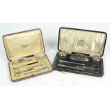 Two George V hallmarked silver mounted travelling manicure sets,