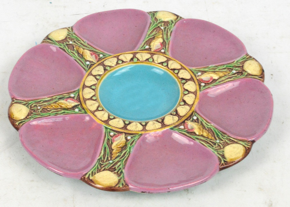 A Minton majolica oyster dish, with six pink glazed outer recesses, impressed marks, no.1323,