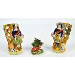 A pair of Victorian Staffordshire figures depicting highlanders with recumbent spaniels, height 18cm