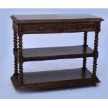 A late Victorian carved oak three tier buffet with twin frieze drawers and moulded plinth base,