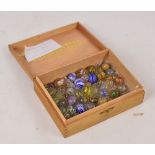 A collection of 19th century handblown glass marbles, all clear with a variety of latticino, gauze