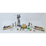 A quantity of collectable golfing items including golf figures, bottle stoppers, paperweights, etc.