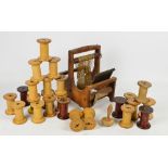 A small wood framed hand loom and a quantity of thread reels, mainly Wilson Bros Bobbin Co Ltd,