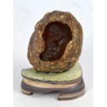 A Chinese carved boulder depicting an elderly man with child, on hardstone base, height 13.5cm.