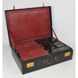 A Dupont travelling case with black exterior and red leather interior with fitted internal case