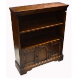 A 20th century oak bookcase with lower twin door cupboard section on bracket feet, width 84cm.